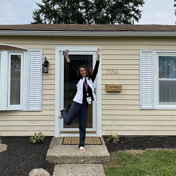 Persistence pays off Homeowner in front of her new home